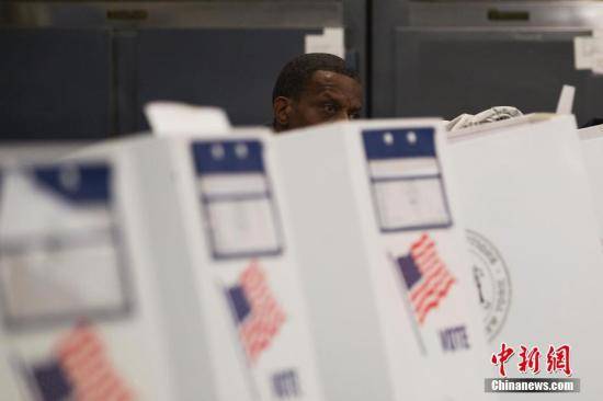 当地时间11月6日，美国2018年中期选举投票日，一位选民在位于纽约布朗克斯区的投票站填写选票。中新社记者廖攀摄
