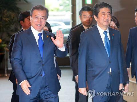 5月9日，在日本首相官邸，文在寅和安倍晋三走向午餐地点。（韩联社）