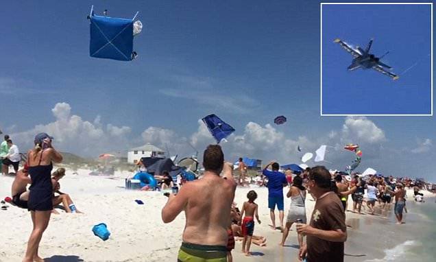 美国海军“蓝天使”飞行表演队飞机低空飞越佛罗里达海滩将游客帐篷卷上天空