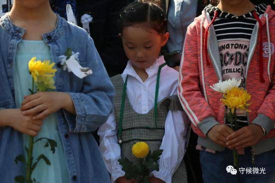 4月6日，成都市烈士陵园，一个小女孩手捧鲜花，向烈士默哀。中国青年报·中青在线记者王鑫昕/摄