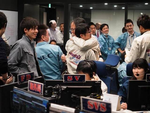 JAXA人员获悉探测器成功降落后，兴奋得互相拥抱。