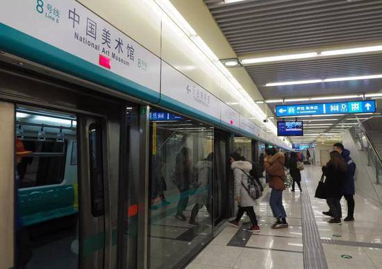 ▲资料图片：乘客在北京地铁8号线中国美术馆站乘车。