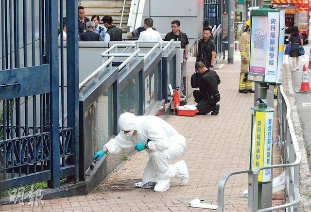 香港警方调查汽油弹投掷现场（图片来源：香港《明报》）