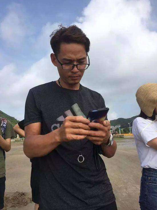 失踪女童的父亲章军，正在翻女孩失踪前的视频和照片。