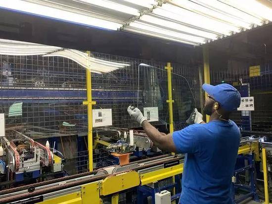 7月27日，在美国俄亥俄州代顿地区莫瑞恩市的福耀玻璃美国有限公司，一名员工检验玻璃外观。新华社发王铁汉摄