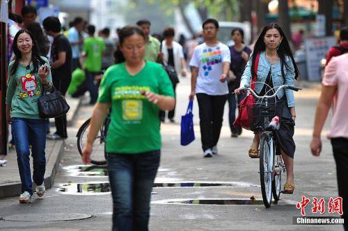 资料图：“白露身不露”，北京街头行人“混搭装”出行。金硕摄