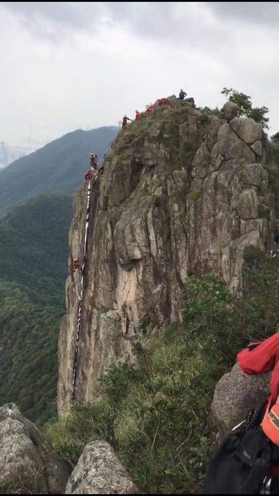 爱国团体登狮子山挥舞国旗 涉险摘除反对派标语