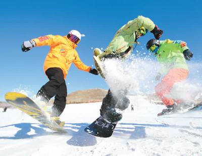 在内蒙古兴安盟突泉县宝石滑雪场，三位单板滑雪爱好者正尽情玩耍。康毕力格摄