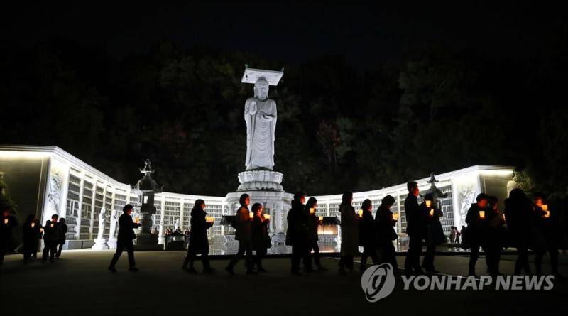 9日晚上，韩国学生与家长聚在奉恩寺，祈祷高考旗开得胜。（纽西斯通讯社）