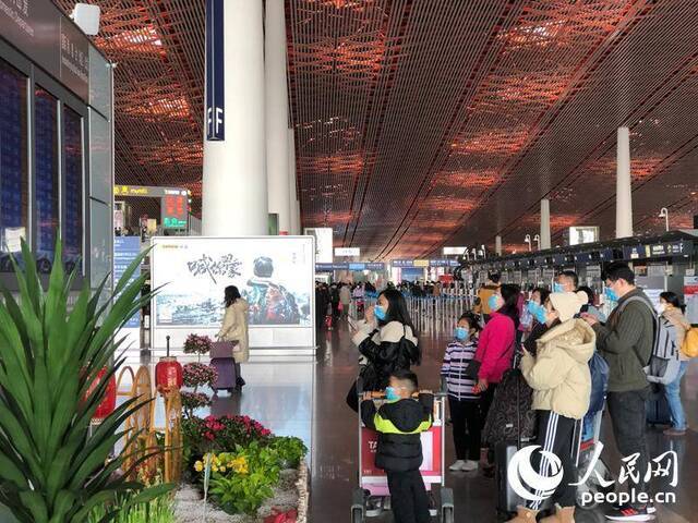 在首都机场T3航站楼，绝大多数旅客都已自觉配戴口罩。人民网记者崔东摄