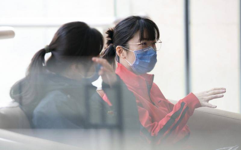 3月16日，武汉，北京安定医院沙莎（右）为北京医疗队队员疏导情绪。摄影/新京报记者陶冉