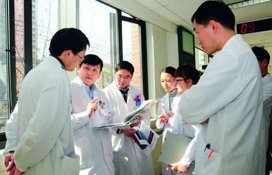 ·张文宏（左二）与同行和学生交流业务、传授经验。