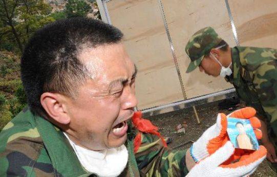 ▲2008年5月15日，在北川县城参与救助的解放军官兵发现儿童的照片，忍不住痛哭。