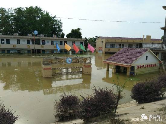 水中的昌洲北兴村小学，大部分校门浸泡在水中，水位下降1米左右后，教学楼一楼的窗子已经能露出60厘米左右。