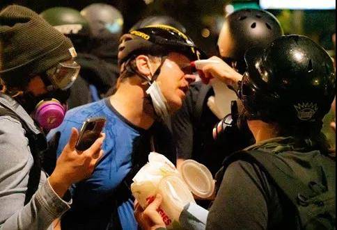 △波特兰抗议者被喷射胡椒喷雾，志愿者对其进行救助