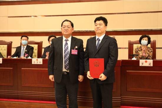 ▲深圳市人大常委会主任骆文智（左）为刘国周颁发任命书。
