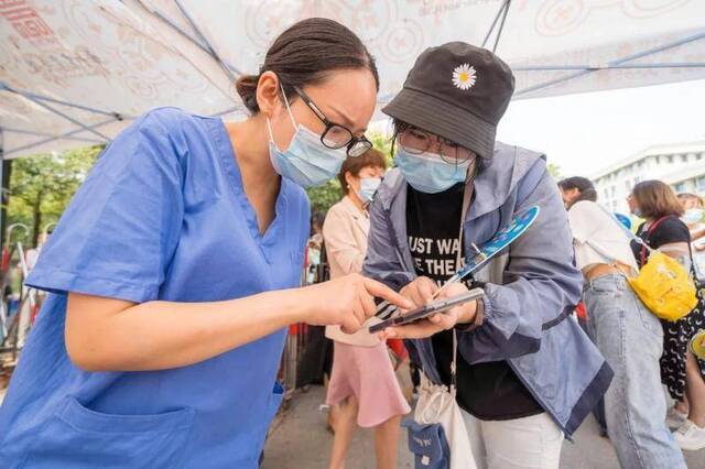 校医院工作人员在核验报到新生健康码（刘博文摄）