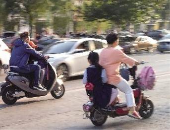 家长和孩子共乘电动车，安全隐患极大。本组图片由辽沈晚报记者吴章杰摄