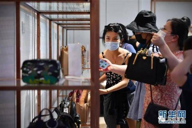 资料图：10月5日，游客在三亚国际免税城购物。新华社记者郭程摄