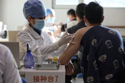 ▲接种台前，接种人员有序接种疫苗。新京报记者王嘉宁摄