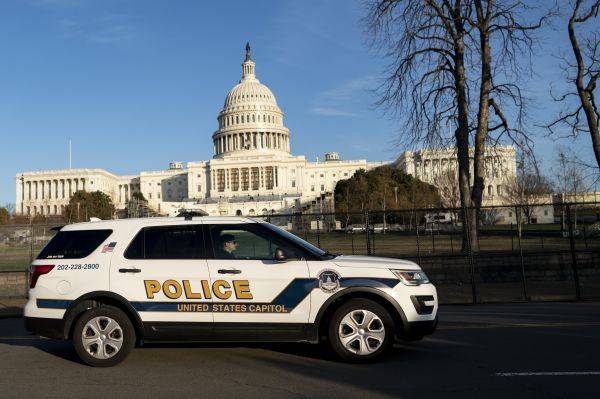1月7日，在美国华盛顿，一辆警车从国会大厦前驶过。（新华社）