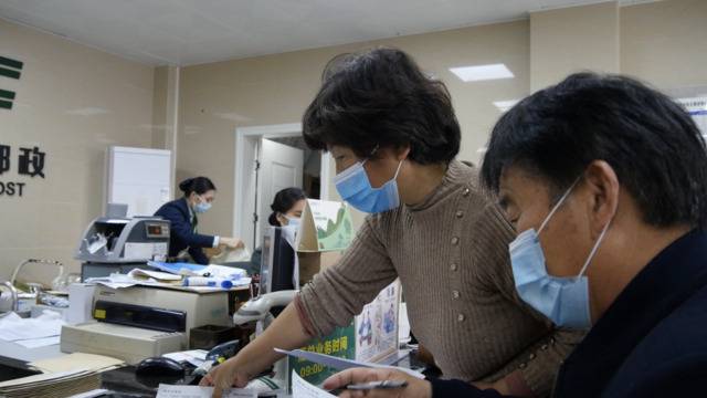 姚策亲生父母在邮政局邮寄建议书。新京报记者刘名洋摄