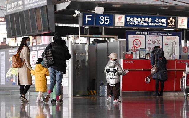 首都机场三号航站楼内，旅客前往值机柜台办理值机手续。摄影/新京报记者陶冉