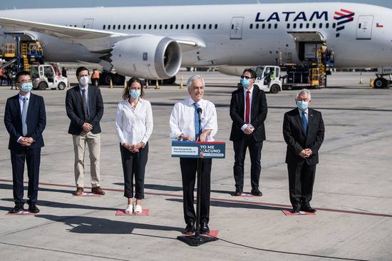 1月28日，在智利圣地亚哥国际机场，智利总统皮涅拉（右三）迎接首批中国新冠疫苗并发表讲话。新华社发（豪尔赫·比列加斯摄）