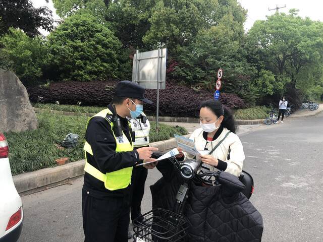 上海非机动车新规五一将至，松江警方在大学城发传单劝导提醒