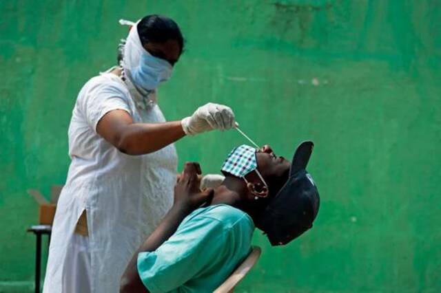 4月9日，印度海得拉巴的一处卫生中心，医务人员正进行新冠病毒检测采样。图/人民视觉