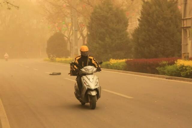 一名外卖配送员在张掖市甘州区街头骑行陈礼摄