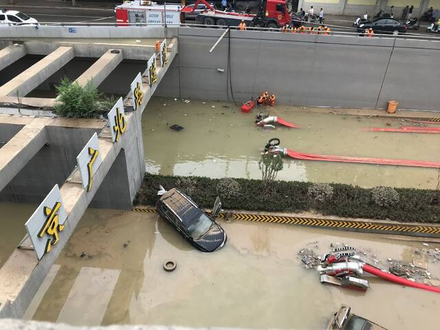 7月23日，京广北路隧道南口，仍有少量汽车泡在水中，几台“龙吸水”抽水机同时抽水。新京报记者聂辉摄