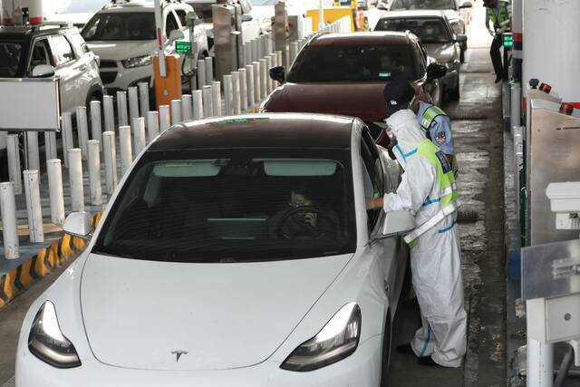 8月6日下午，房山区窦店公安检查站，警务人员在核查过往进京人员身份证和行程码。新京报记者王嘉宁摄