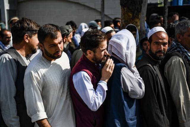 当地时间2021年9月1日，在喀布尔的一个商业区，阿富汗人排队等待银行开门营业。