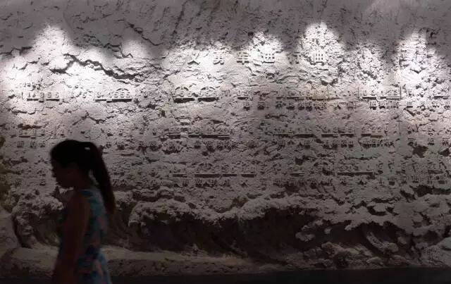 参观者经过沈阳九一八历史博物馆内的《义勇军进行曲》浮雕墙。新华社记者李钢摄