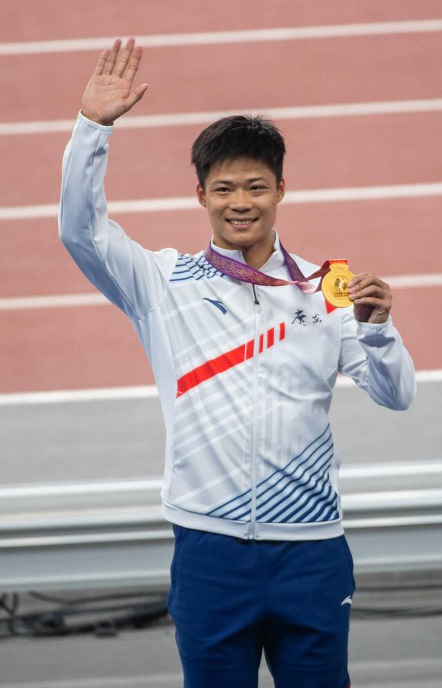 苏炳添展示全运会百米金牌。