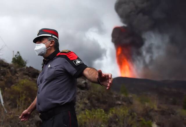 9月22日，警察在西班牙拉帕尔马岛老昆布雷火山附近阻止游人靠近。新华社发（古斯塔沃·巴连特摄）