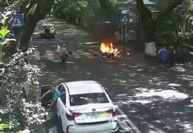 7月18日，杭州玉皇山路电瓶车在行驶过程中自燃，车上父女被烧伤。图/网络截图