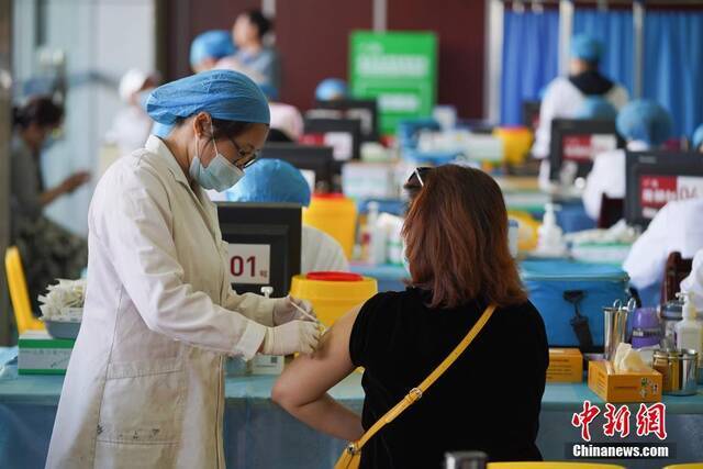 资料图：市民在接种点接种疫苗。中新社记者刘冉阳摄