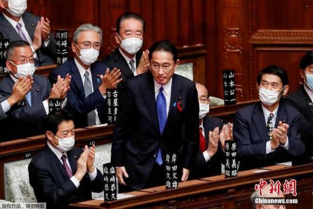 资料图：当地时间10月4日，日本自民党总裁岸田文雄（中）经过众院全体会议的首相指名选举，成为第100任首相。