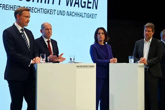 当地时间2021年11月24日，朔尔茨（左二）出席新闻发布会，宣布三党达成组阁协议。左一为自民党主席林德纳，左三、左四为绿党双主席贝尔伯克和哈贝克。澎湃影像资料图
