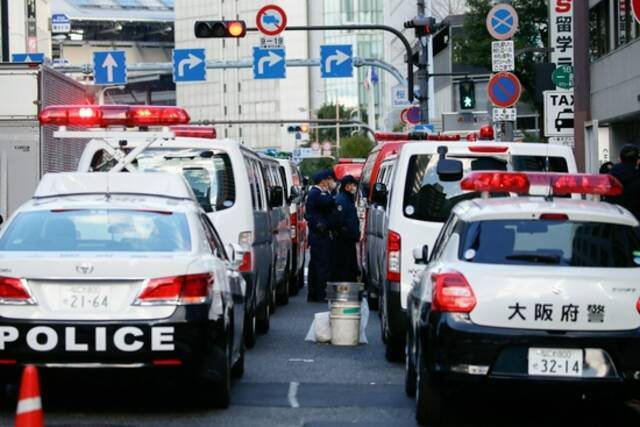 当地时间12月18日，警车和消防车停在日本大阪的火灾现场附近。新华社图