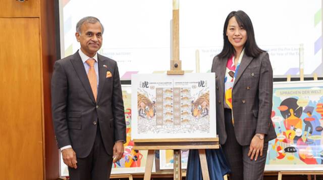 图为联合国驻华协调员常启德（左）与联合国邮政管理局亚洲联络处代表初微微（右）为邮票揭幕。