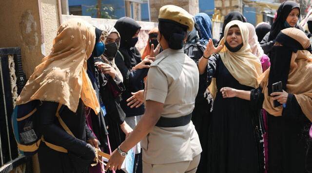 2月17日，戴着头巾的穆斯林学生在卡纳塔克邦班加罗尔的一所公立学校聚集抗议时，与一名女警察发生冲突。图自印媒