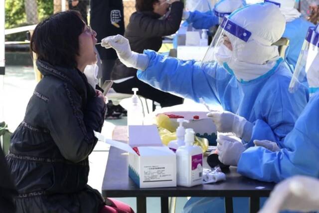 ▲4月6日，医务人员在上海市普陀区长风新村街道为居民进行核酸检测采样。（新华社记者陈飞摄）