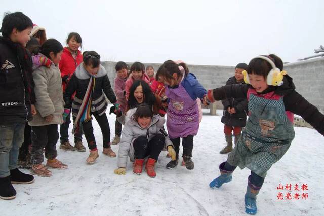 雷宇丹和学生们在雪地里玩。