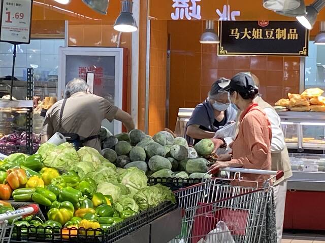 家乐福超市内，蔬菜供应充足，市民正在挑选蔬菜。受访者供图