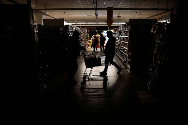 当地时间2022年10月17日，乌克兰哈尔科夫，当地停电，民众摸黑在超市购物。澎湃影像图