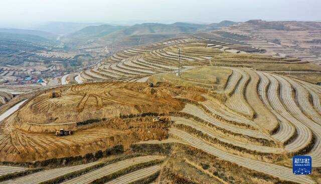 2月7日，工人操作挖掘机、推土机在宁夏固原市西吉县硝河乡苏沟村平整土地（无人机照片）。新华社记者冯开华摄