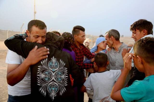 2017年5月30日，在伊拉克摩苏尔东部约30公里处的哈桑沙姆U2安置营地，刚从交战区撤出的平民见到家人相拥而泣。新华社发（哈利勒·达伍德摄）